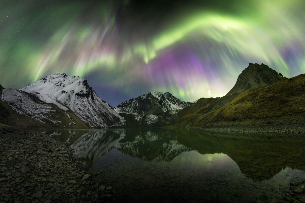 massive solar storm over mountain range in the Yukon