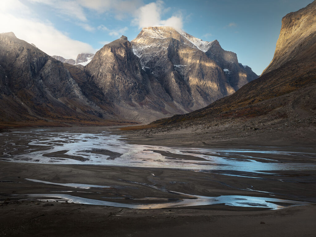 Mount Odin towers over a river valley in the Arctic