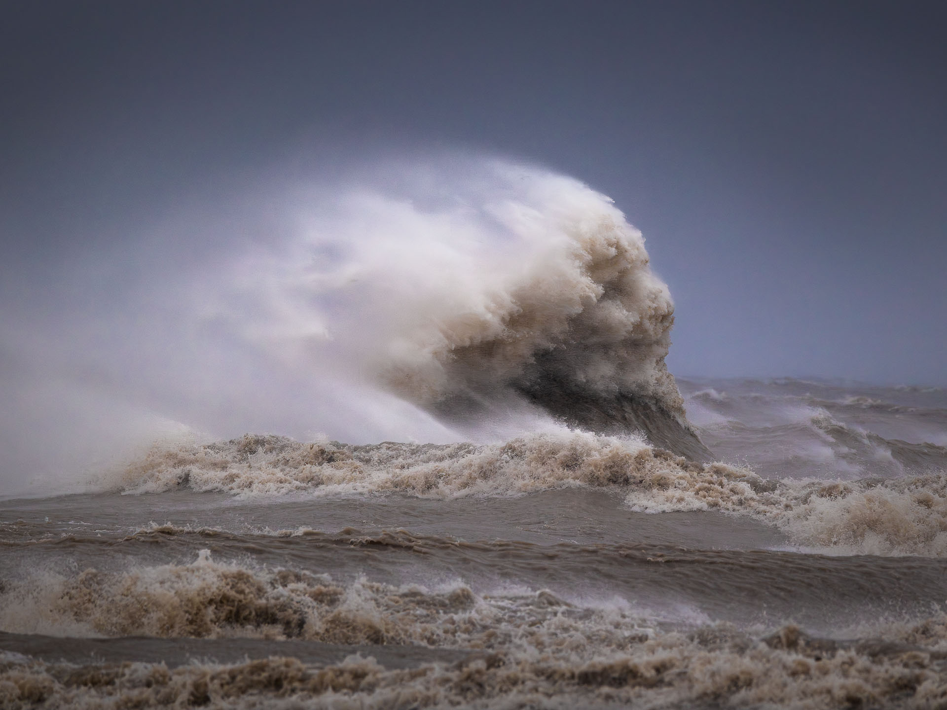 Smile-2025-P A wave resembling a face leaps out of a lake