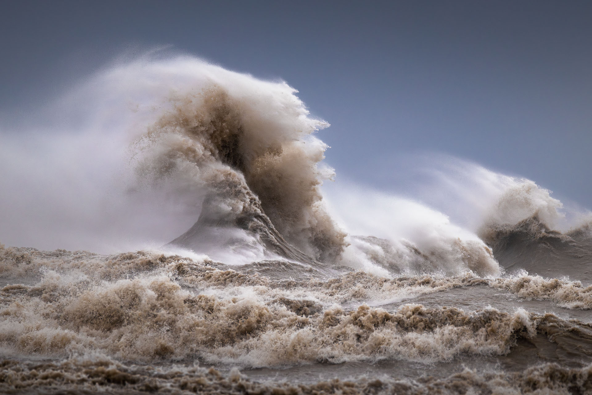 blooming-2025-P A large wave rolls over amid high wind