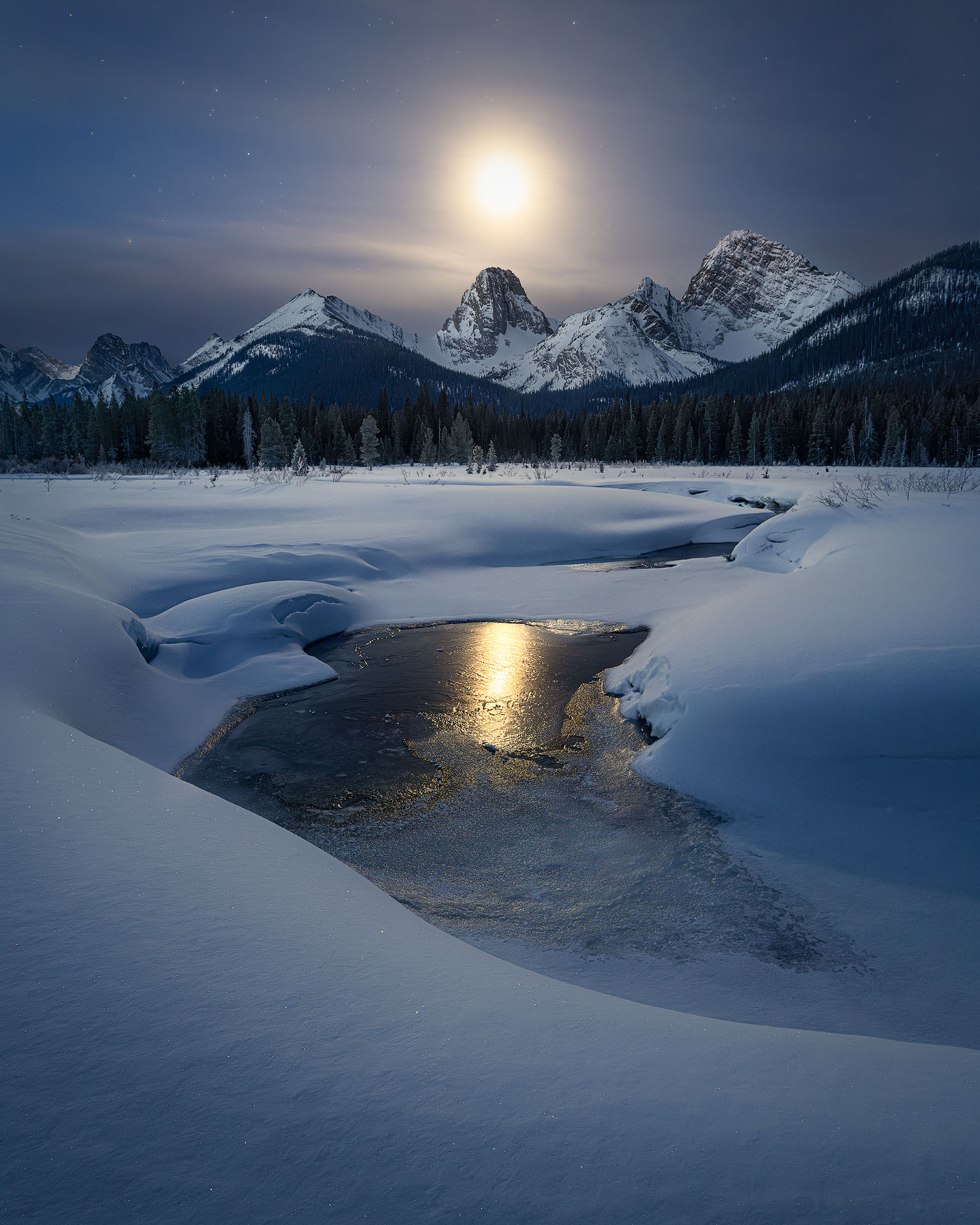 Under the night sky-2026-P The moon sets over a winter mountain landscape